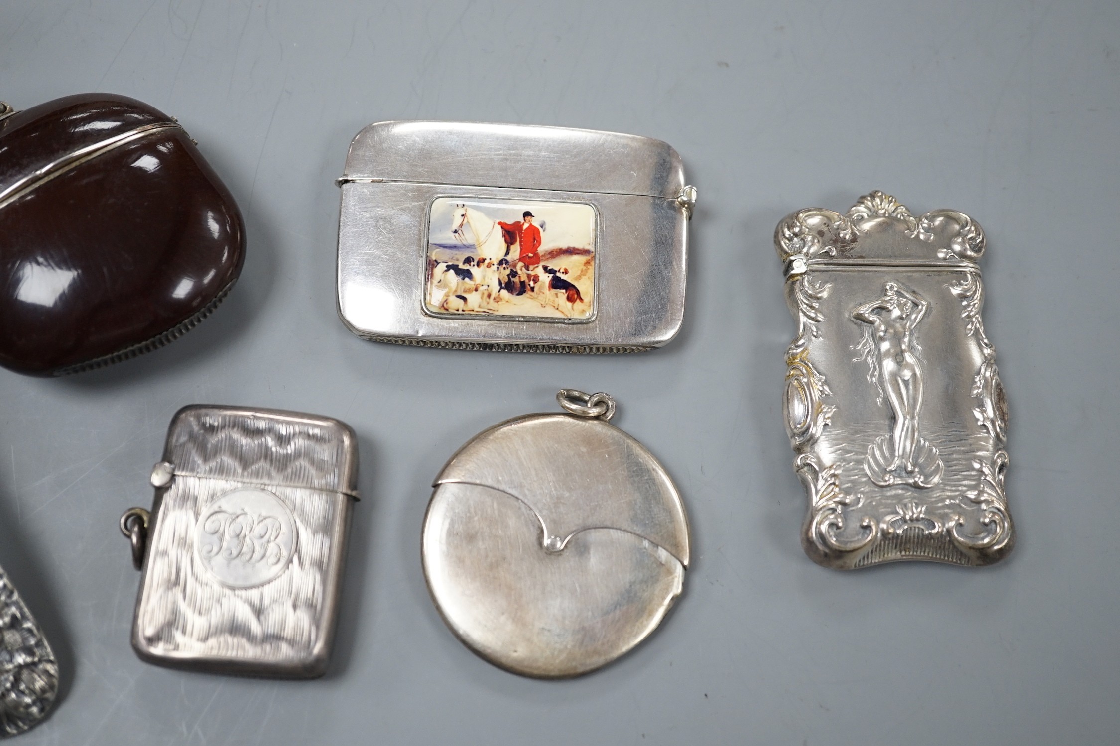 Four assorted early 20th century silver vesta cases, including a silver gilt mounted nut, and patent action circular, together with a sterling vesta case and ornate handled sauce ladle and a mother of pearl handed silver